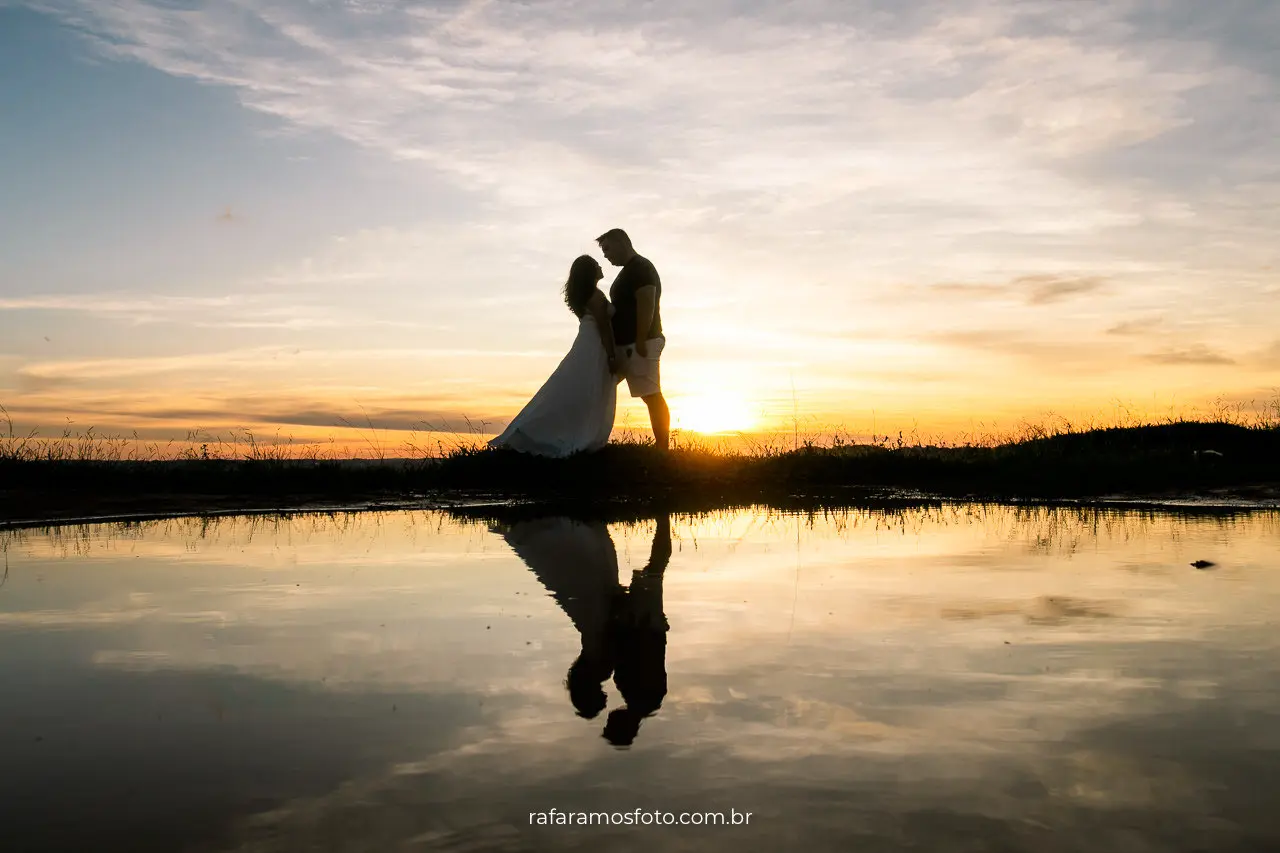 Silhueta de noivos nas montanhas durante ensaio pré wedding ao pôr do sol